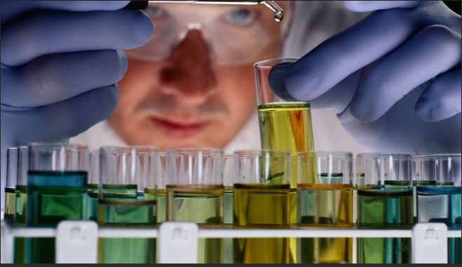 chemist holding test tubes